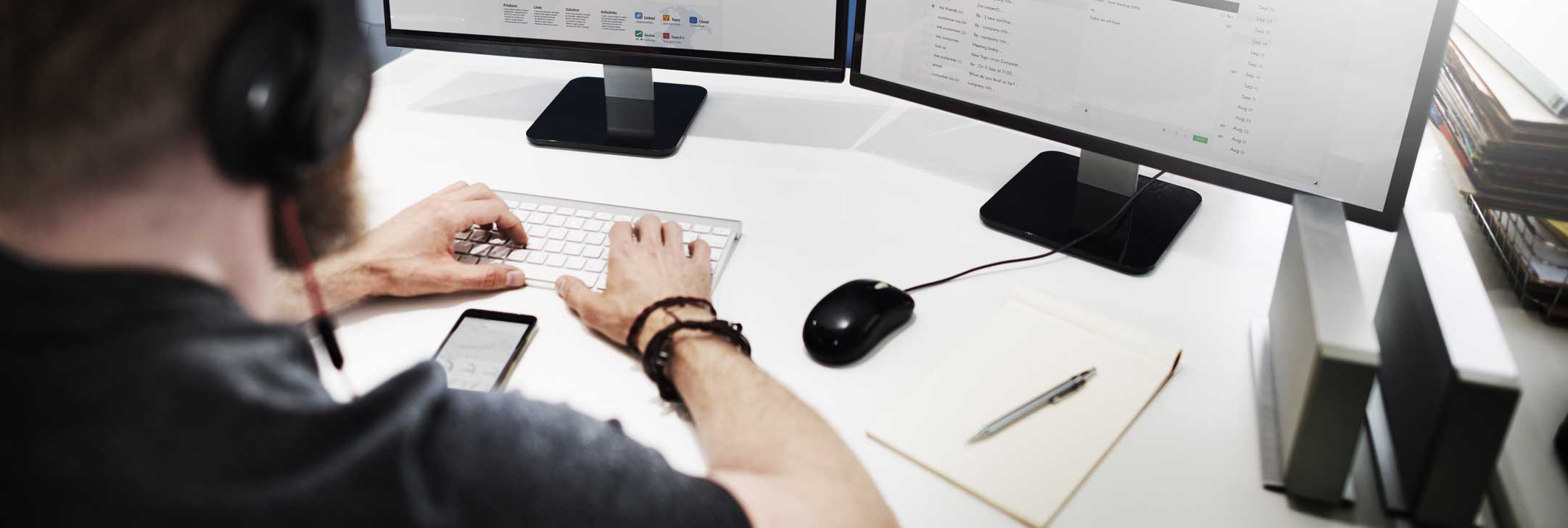 person at a desk working on a computer